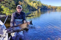 A single angler holding a big fish in MI