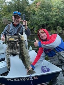 Two anglers with a large 23-inch fish catch in Alma