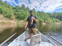 A single fisherman holding a fishing rod in Alma