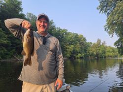 A lone fisherman in Alma, holding a 15-inch catch