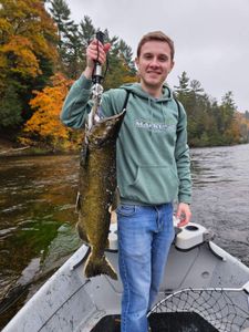 A person fishing in the town of Alma