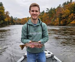 Angler holding a beautiful Rainbow Trout in Alma