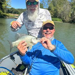 Angler proudly holding a 13-inch crappie in Fort Smith