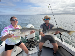 Huge striped bass double-header in Barnstable's partly cloudy waters!