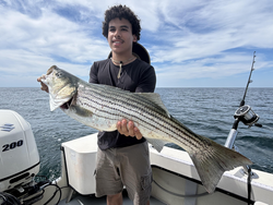 Big 37-inch Striped Bass landed in Barnstable's partly cloudy waters!