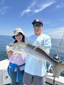 Striped Bass action in Barnstable with mixed techniques under partly cloudy skies!