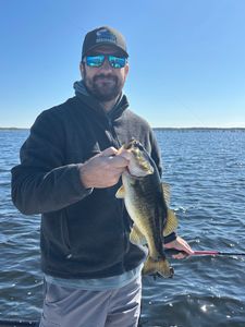 Angler holding freshly caught bass on lake in Interlachen FL