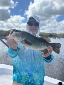 Angler holding freshly caught bass on fishing boat in Interlachen FL