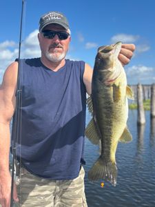 Angler holding freshly caught bass while fishing in Interlachen FL
