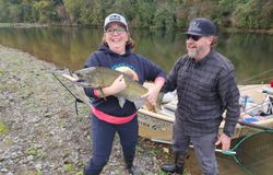 Two people enjoying a day of fishing for a rainbow trout in OR