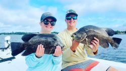 Two anglers fishing in FL with two big fish