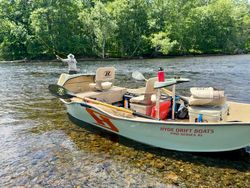 Hyde Drift Boats Pro Series XL fishing boat on clear river water in South Portland ME with fly fishing rod and equipment