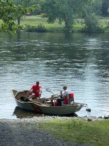 Fishing boat on calm river in South Portland ME with fishing gear and equipment