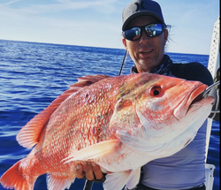 A fisherman catches a 25-inch fish at New Smyrna Beach