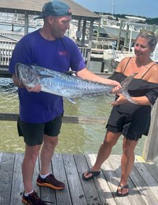 A fisherman catches a large 23-inch fish at Wrightsville Beach