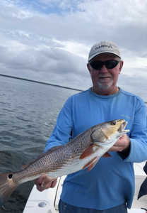 A person fishing on the coast of FL