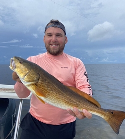 A fisherman holding a 24-inch catch in Florida.