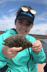 A person fishing in Steinhatchee with a small fish