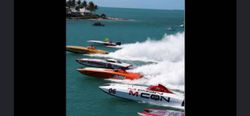 High-speed powerboat race in turquoise waters near St. Petersburg FL with multiple racing boats creating white spray wakes