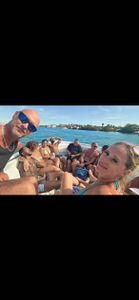 Group enjoying water sports boat tour in St. Petersburg FL with coastal waters and shoreline visible