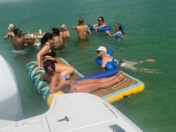 Water sports group enjoying floating platform and swimming activities in St. Petersburg FL waters