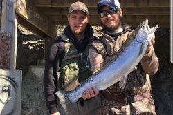 Proud angler with a beautiful rainbow trout in Wisconsin
