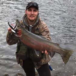 Proud angler with a beautiful rainbow trout in Iron River