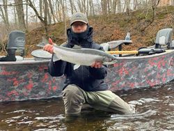 A fisherman with a rainbow trout in NY