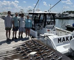Four people fishing at Rehoboth Beach
