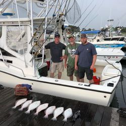 Three people fishing at Rehoboth Beach