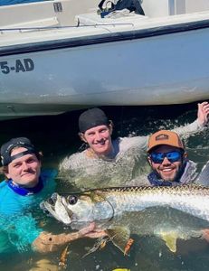 An angler holding a 26-inch fish in PR