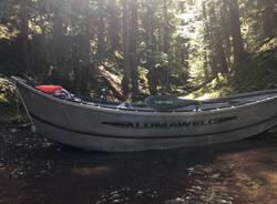 Alumaweld fishing boat positioned in forest stream in Clackamas Oregon