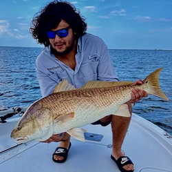 Fisherman with a large 25-inch catch in Port Sulphur