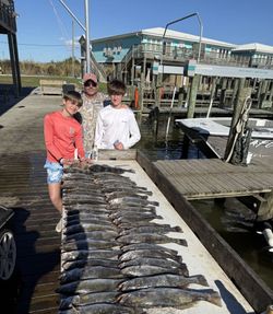 Three people enjoying a fishing trip in Port Sulphur