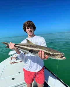 Fisherman catching a 28-inch fish in FL