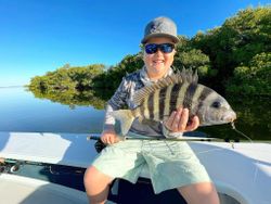 A fisherman holding a 18-inch sheepshead in Islamorada