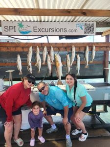 3 people fishing on the beach at South Padre Island