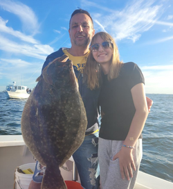 Angler holds a Southern Flounder fish in NY