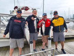 Anglers with 3 rainbow trout and mahi mahi caught fishing in Milwaukee