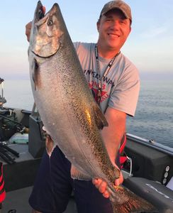 A person fishing in Sheboygan with a 30-inch catch
