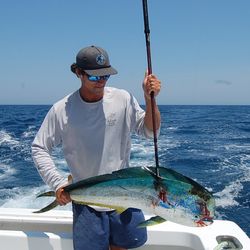 Angler holding a mahi mahi fish in Weldon