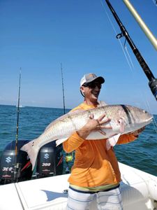 Angler catches a lone fish in the waters of Cape Charles