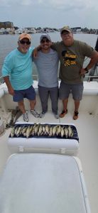 Three anglers fishing on the pier in Port Clinton