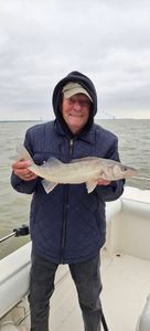 Angler holding freshly caught fish on fishing boat in Port Clinton OH