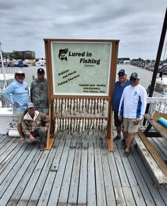 Successful fishing charter displaying large catch of walleye and perch on dock in Port Clinton OH