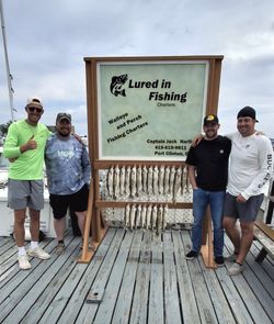 Successful fishing charter displaying caught fish on wooden display board at Port Clinton OH dock