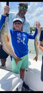 Two redfish caught fishing in Bonita Springs FL displayed on boat deck