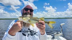 A fisherman catching a 15-inch Snook in Bonita Springs