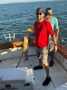 Fisherman catching a 17-inch fish in Gulfport