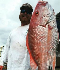 Angler with a big fish in Shalimar